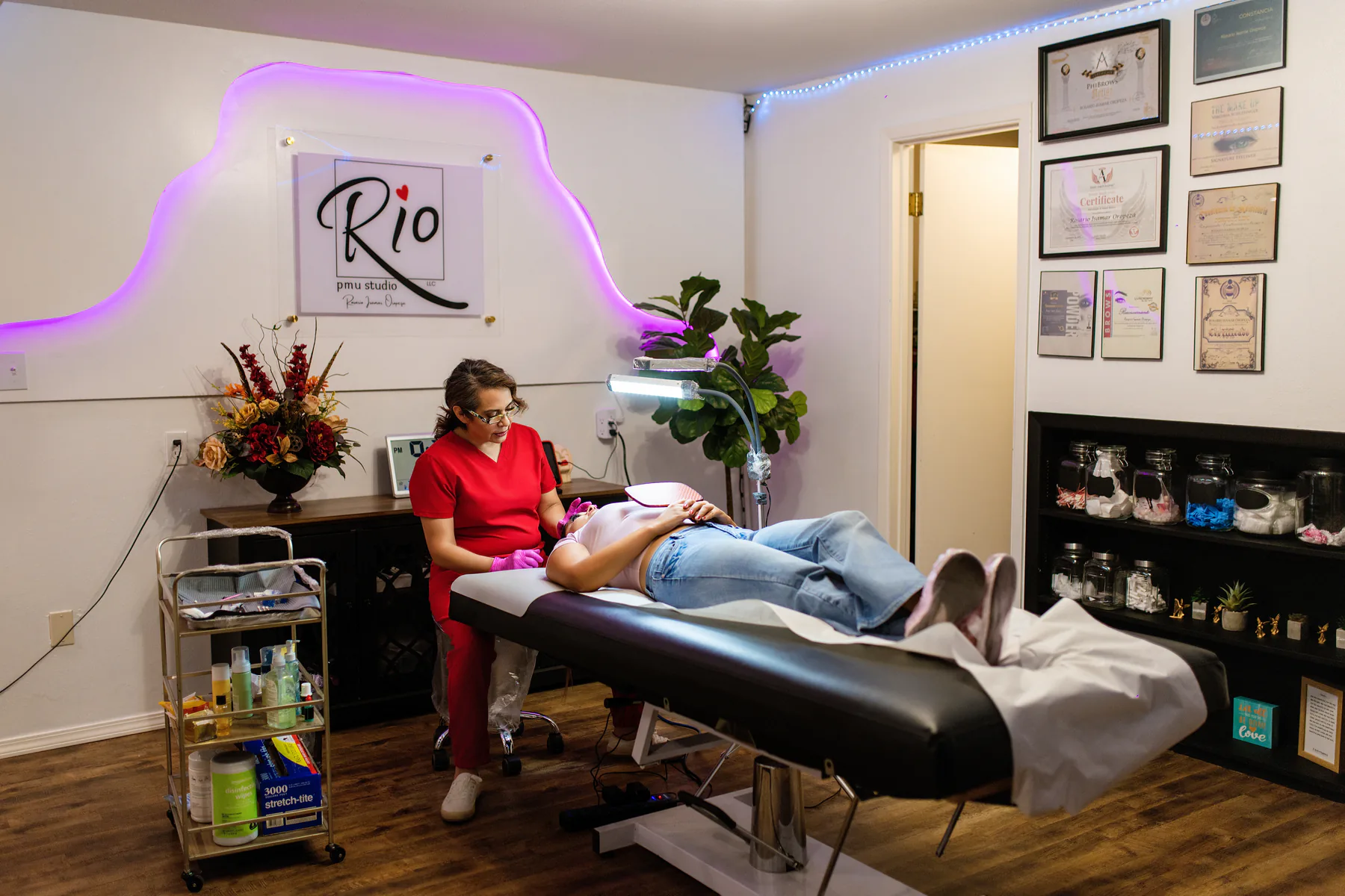 Wide view of Rosario working with a client in the Rio PMU treatment room